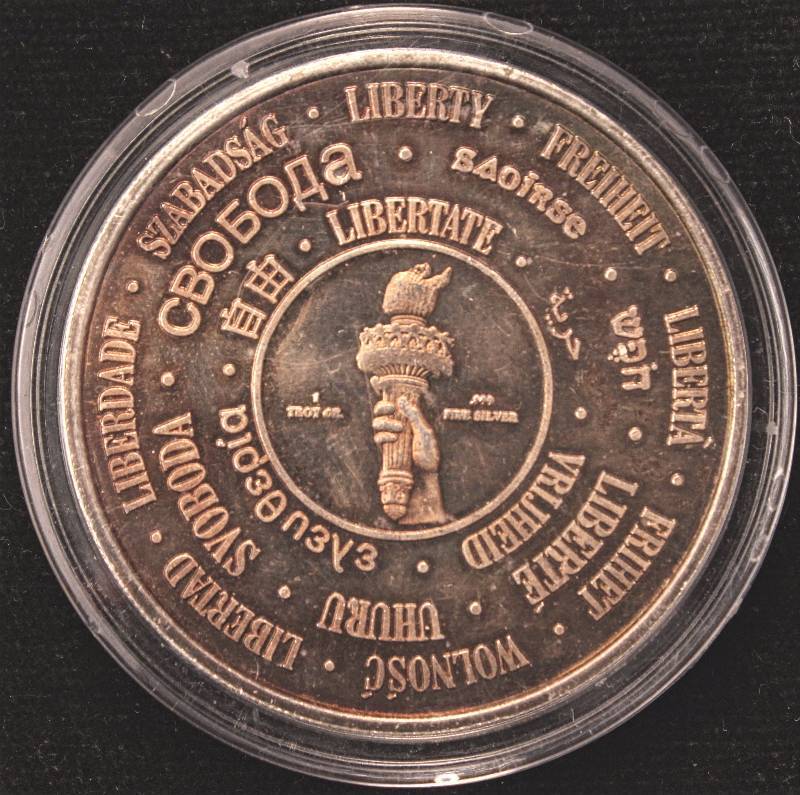 lot 75 image: 1 TROY OZ. .999 FINE SILVER ROUND 1986 STATUE OF LIBERTY NICELY TONED IN AIRTITE HOLDER