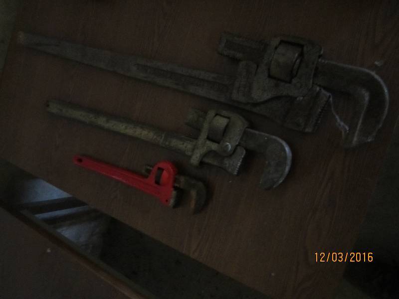 3 sizes of pipe wrenches, small med...