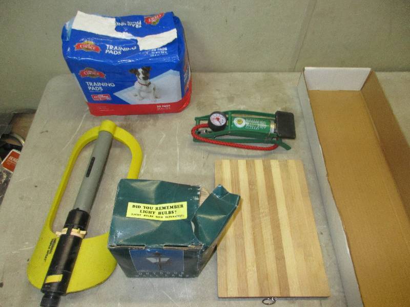lot 69 image: sprinkler - cutting board - outdoor light - dog training pads - bike pump