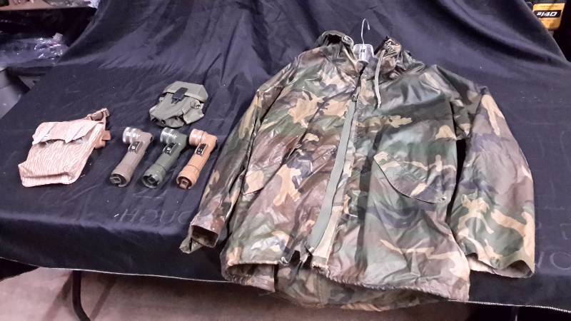 lot 48 image: Camo poncho size medium, 3 military style flashlights with 2 filters, M-16 mag pouch, and miscellaneous mag pouch