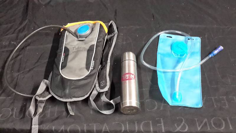 lot 50 image: Hydration lot-runner camelback with extra bladder and 1 thermos
