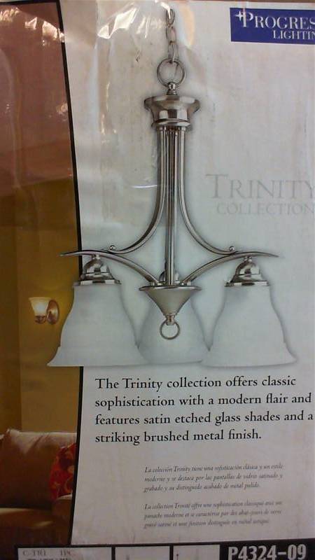 lot 49 image: Progress Lighting Trinity Collection 3-Light Brushed Nickel Chandelier. Unused
