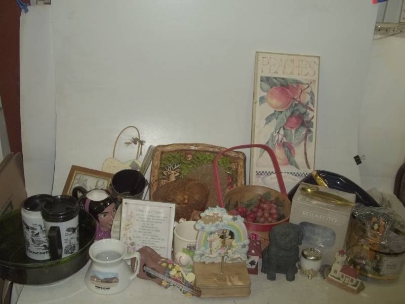 lot 75 image: Brass loon, Minnesota mugs, Cracker Barrel, peaches sign, dog door stopper, artificial grapes basket, etc.