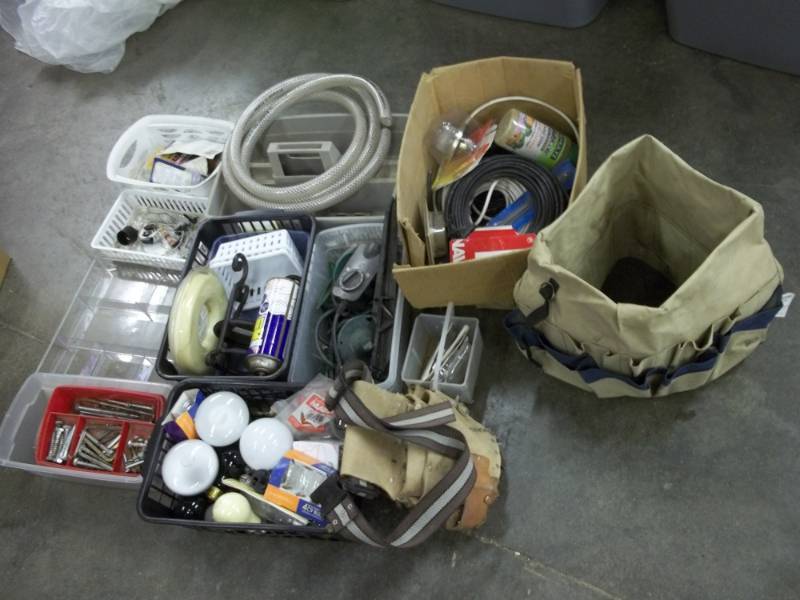 lot 88 image: Light bulbs, chain lube, bolts, hose, bucket bag, BBs, tool belt, co axle cable, weed eater string, parts baskets, etc.