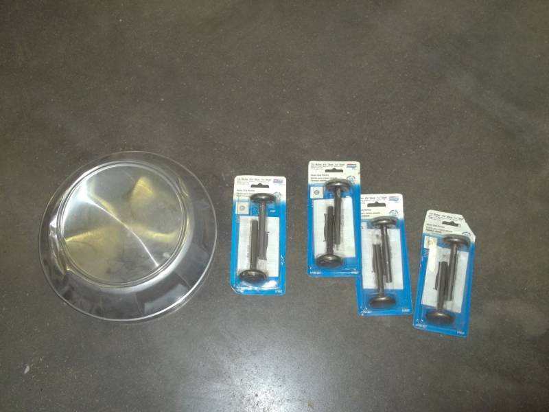 lot 199 image: Hubcap and 4 packages of garage door wheels