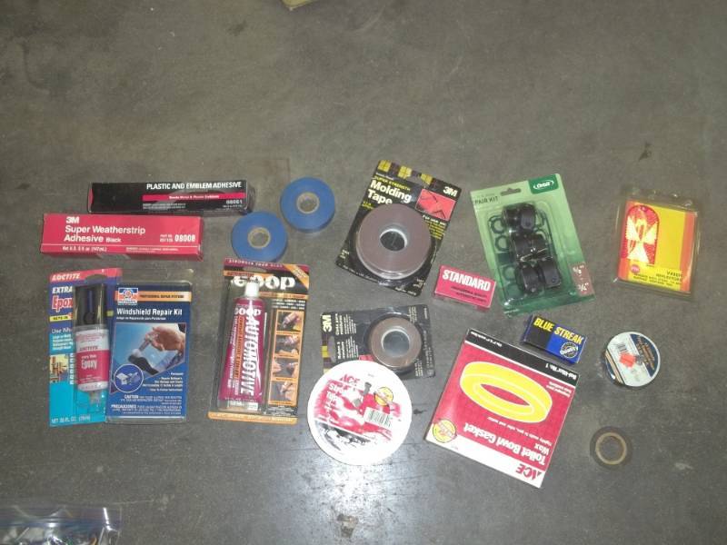 lot 209 image: Goop, weather strips, electric tape, molding tape, reflector