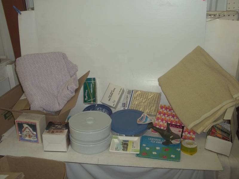 lot 293 image: Blankets, clothes line hooks, rubber orca, kids books, Christmas lights, candle holders