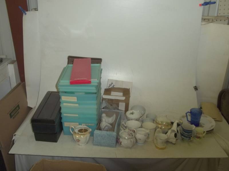 lot 330 image: Tupperware, porcelain doves, porcelain cow, syrup dispensers, teacups, candles, plates