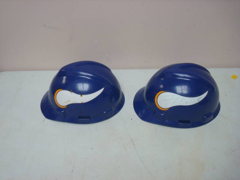 lot 81 image: Pair Of Minnesota Vikings Hard Helmets, Used, Show Lots Of Wear, One Cracked