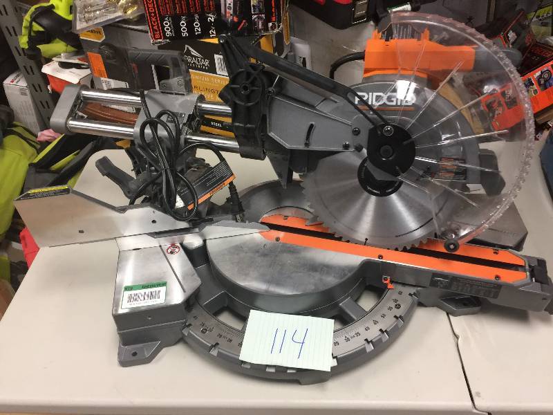 lot 114 image: RIDGID 15 Amp 12 in. Corded Dual Bevel Sliding Miter Saw with 70 Degree Miter Capacity Model#  R4221 used in like new working conditions missing the bag