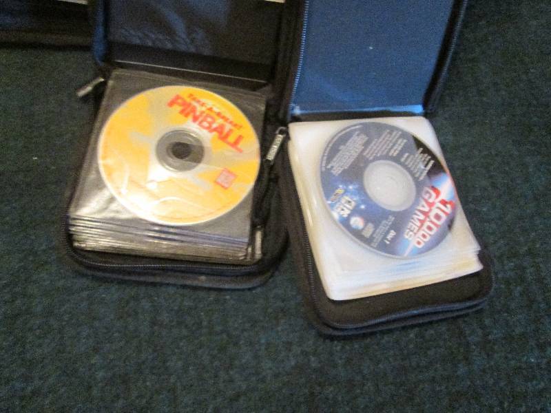 Lot of 2 CD Cases with 7 game discs...