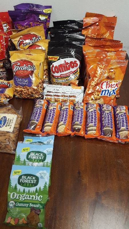 Mixed lot of candy, chips, nuts, gum, and cookies.