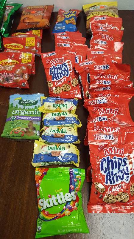 Mixed lot of candy, chips, nuts, gum, and cookies.