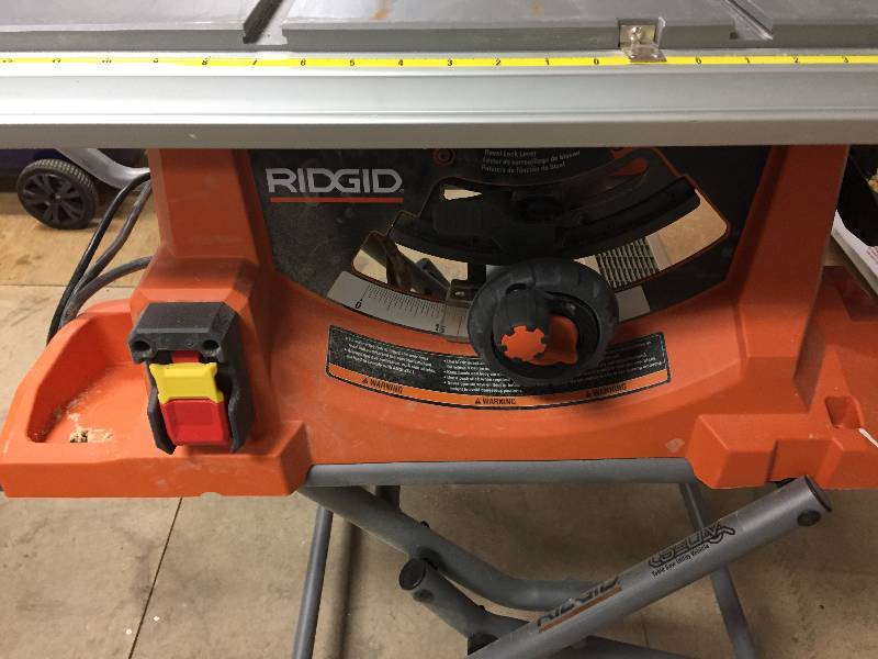 lot 88 image: RIDGID 15 Amp 10 in. Heavy-Duty Portable Table Saw with Stand used in working conditions missig guide rail