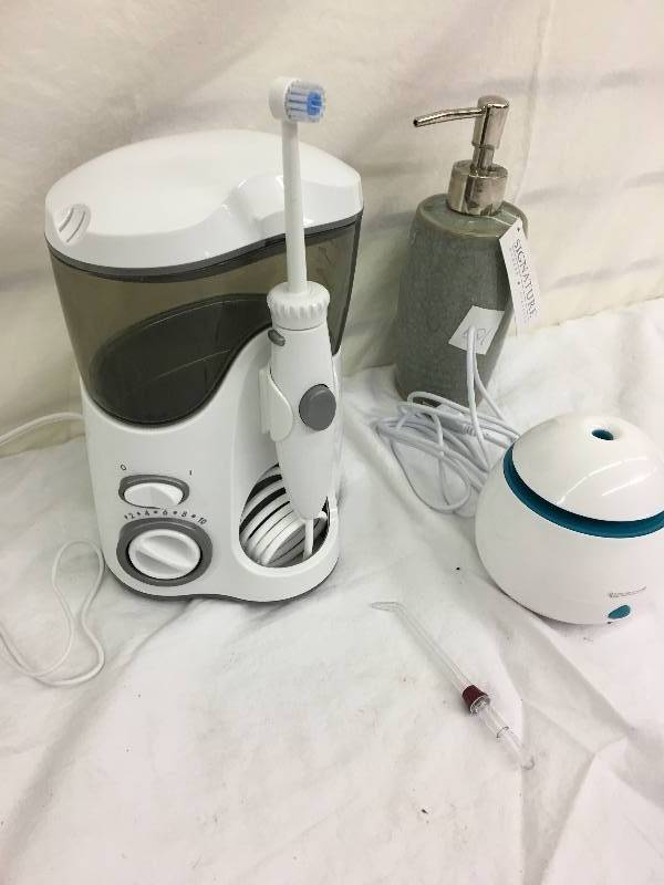 lot 109 image: water pik retail $49    and water flosser