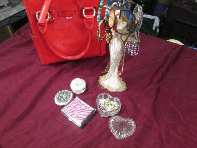 Red Tote containing jewelry on stan...