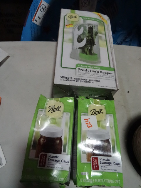 lot 224 image: NEW LOT Ball Brand Canning Items Incl. 6 bottles Bread and Butter Pickle Mix, Fresh Herb Keeper and 2 Boxes Plastic Storage Caps,