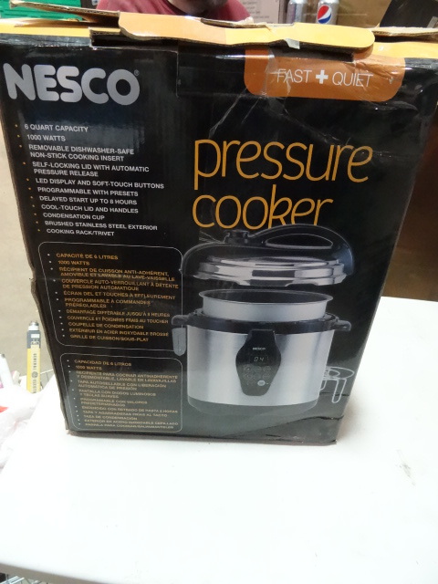 lot 317 image: NEW NESCO Pressure Cooker 6qt 1000 watt Programmable. $85 retail NOTE Bottom of unit damaged in shipping but looks fully functional.