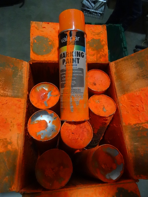 lot 31 image: NEW Qty 8 Cans Fluorescent Orange Marking Paint. A can exploded and covered the pother cans with paint. Other than the cosmetic damage, all is good.