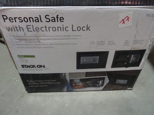 lot 77 image: Stack-On Personal Safe  Was dropped in shipping and is bent out of shape. Lock works but body will need a little TLC