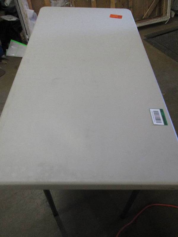 lot 107 image: 4 foot resin table with metal folda...