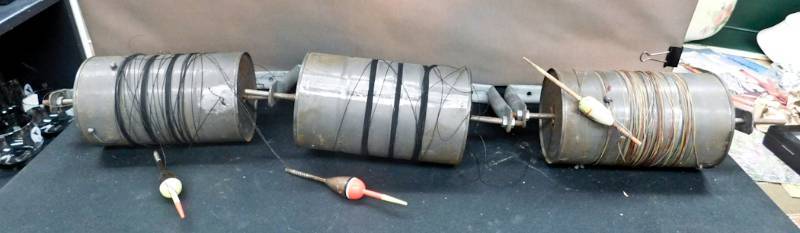 three homemade fishing reels