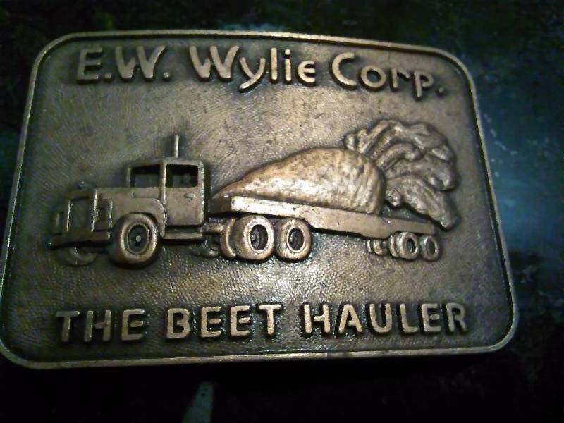 lot 255 image: Vintage Belt Buckle, E.W. Wylie Corp., The Beet Hauler, Semi