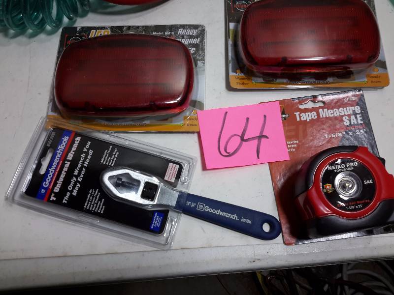lot 64 image: coil air hose, short piece of air hose, 2 emergency battery operated lights Universal wrench 25 ft tape measure