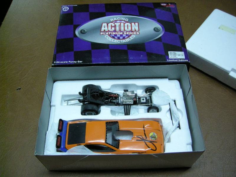 lot 71 image: Signed John Force Action Platinum Die Cast Funny Car