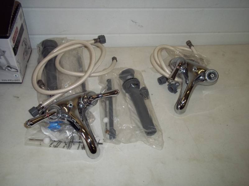 lot 18 image: Pair of Bathroom faucets, drains and hoses, one faucet had broken handle