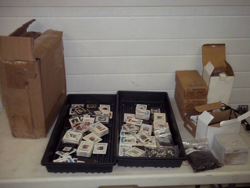 lot 38 image: Miniature picture frames, Case of boxes, track light, light bulbs, transformer, Garage door safety light.