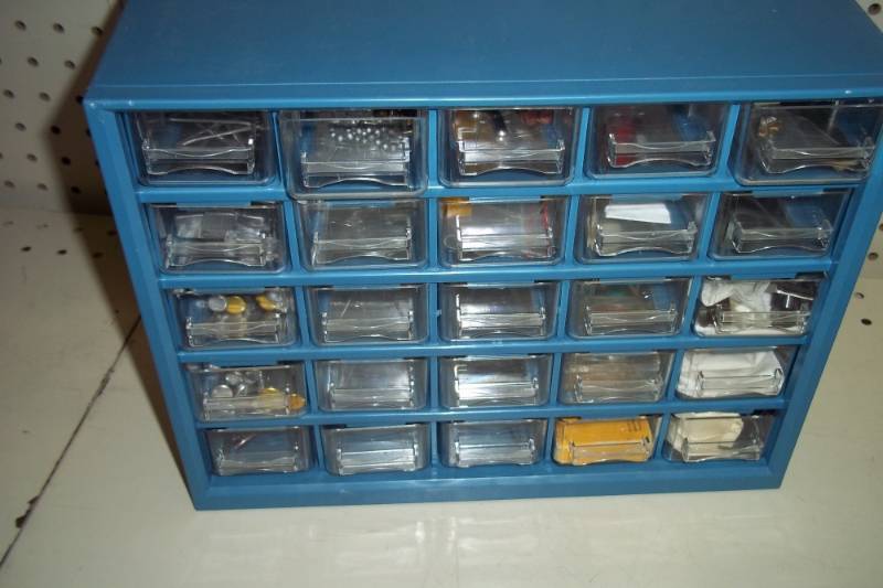 lot 329 image: Parts organizer with lenses, parts, rivets, and miscellaneous items
