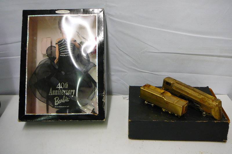 lot 91 image: Barbie Doll 40 anniversary 2 tin train cars