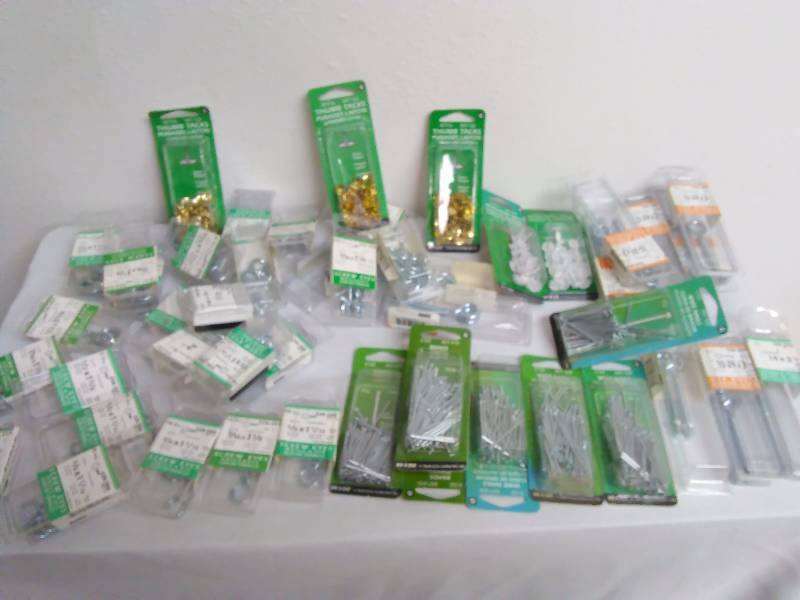 lot 420 image: Hardware Variety, large lot, (169 pkgs.) This lot contains new in package, thumb tacks, nails, brads, upholstery tacks, screw variety, and MORE. There are 169 packages total