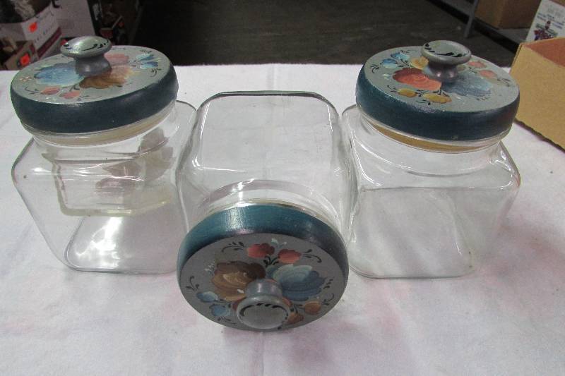lot 69 image: set of 3 glass canisters with wood rosemal painted tops