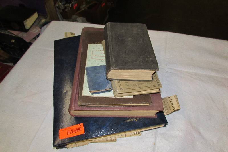 lot 80 image: books, scrapbook on the Sioux, Bible and song book.
