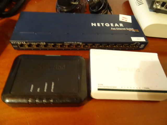 lot 21 image: Tenda 8 port fast ethernet switch. S100. Net gear fast ethernet switch. FS116. Action tech ethernet hub.GT701D