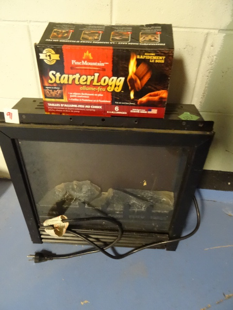lot 91 image: Electric in wall fireplace heater. 18 x 17. Pine mountain starter logs.