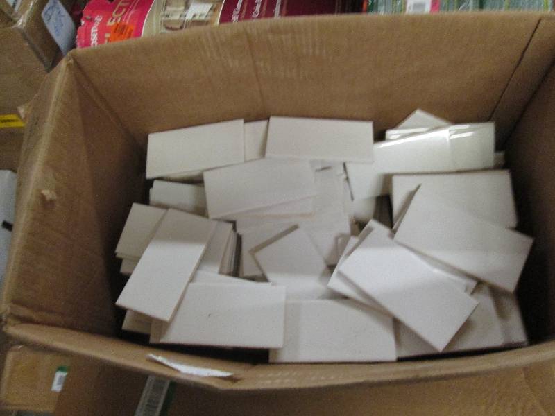 box of 3x6 white tile and a under...