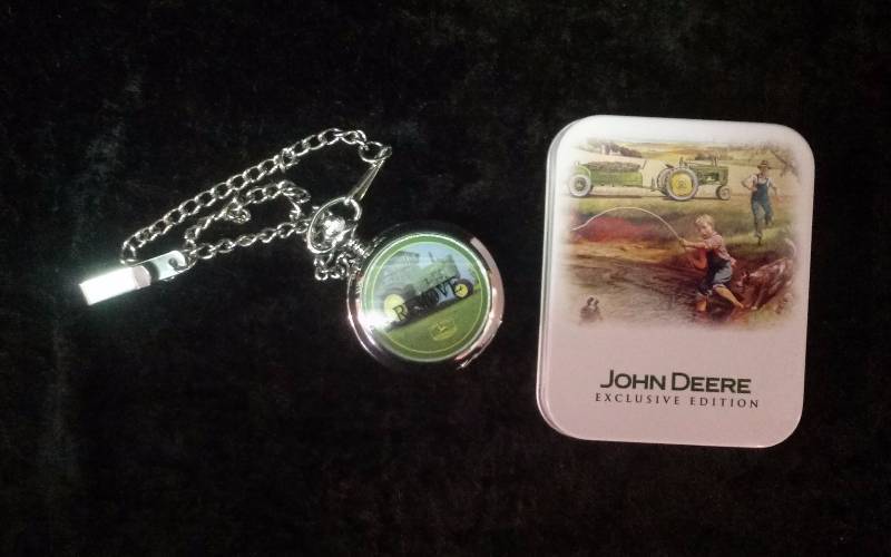 lot 2 image: Avon John Deere Pocket Watch in Tin, needs battery