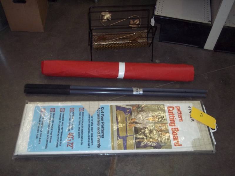 lot 40 image: Singer pattern cutting board, small roll of vinyl, metal handles, metal dcor basket