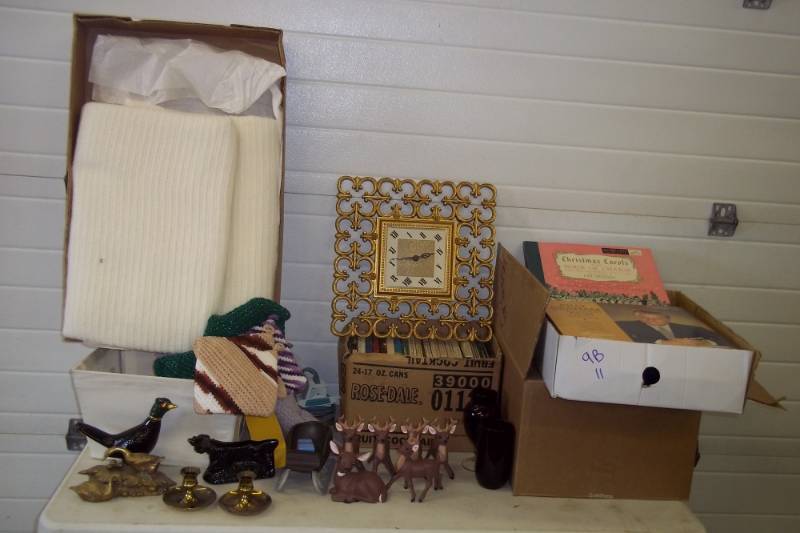 lot 106 image: Brass geese, brass candle holders, record sets, clock, full box of red glassware, magnetic tapes, 2 irons, blankets, homemade potholders, glass pheasant