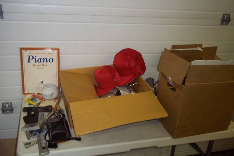 lot 126 image: .38 ACP pistol holster, assorted 70s and 80s National Geographic magazines, vented caps, office supplies, piano lesson books,