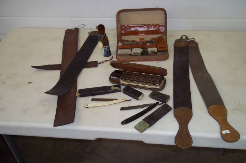 lot 105 image: Leather straps, straight razors, Rolls Razor blade sharpener, vintage toiletry kit