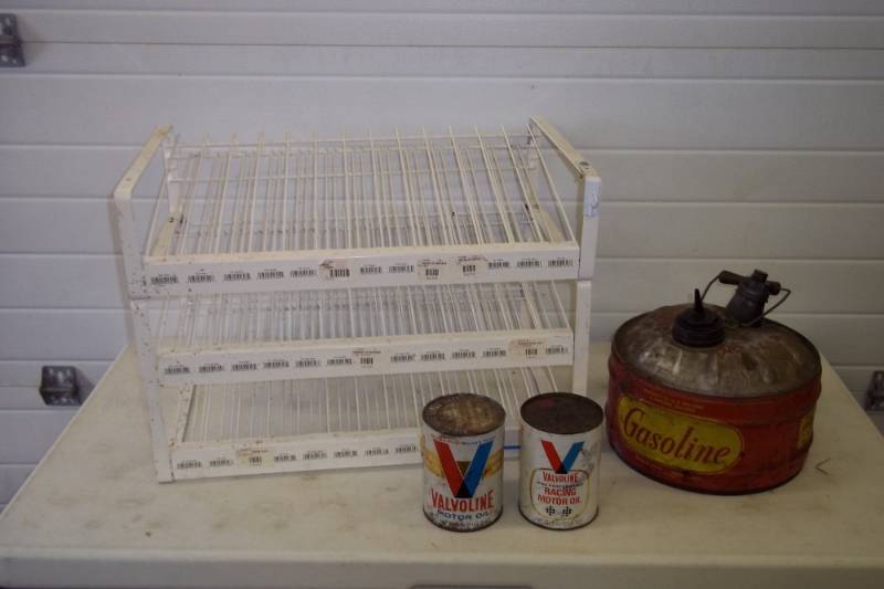lot 116 image: Supply rack, vintage metal gas can, Valvoline oil cans, empty