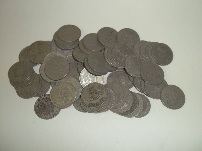 lot 8 image: Seventy One $1 Pecos Mexican coins, mixed dates