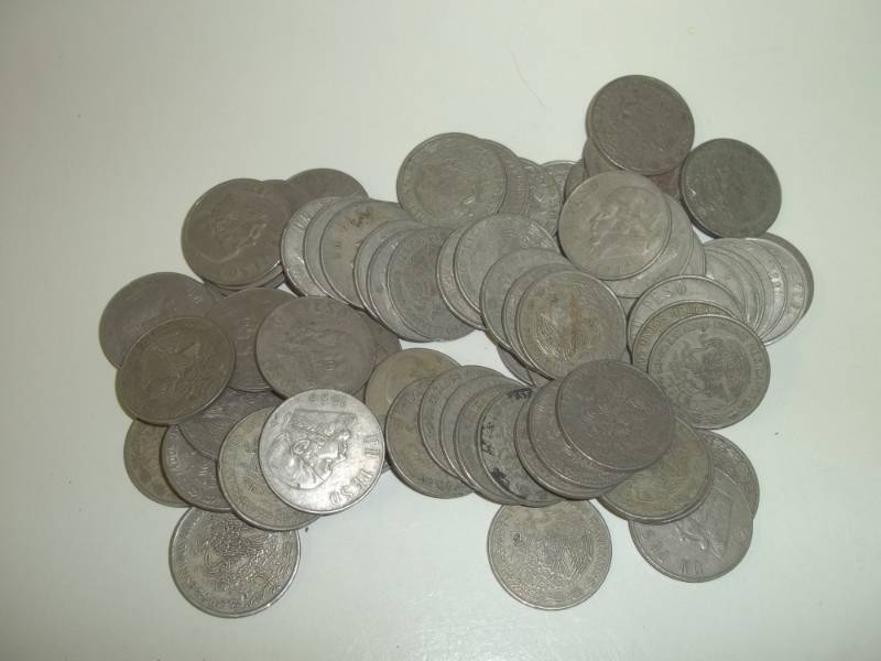 lot 9 image: Seventy One $1 Pecos Mexican coins, mixed dates