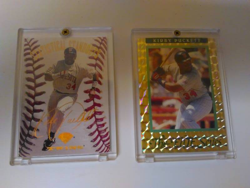lot 654 image: 2- Kirby Puckett Baseball Cards, Secured Case, 1) Statistical Stand-outs, 1995 Dunruss 03135000 2) The Elite Series, 1991 Leaf 103610,000