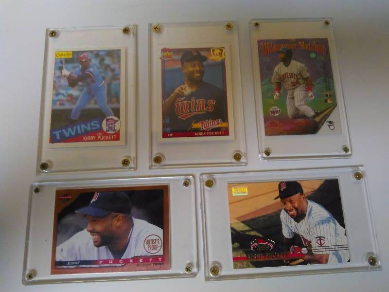 lot 655 image: Kirby Puckett Baseball Cards, set of 5 Cards, in Secured Cases, 1985 O-Pee-Chee 1991 Topps (Operation Desert Shield) 1995 Upper Deck, Mid-Summer Match Up, All Star Game 1996 Score 45110 Artist Proof 1993 Topps Stadium Club