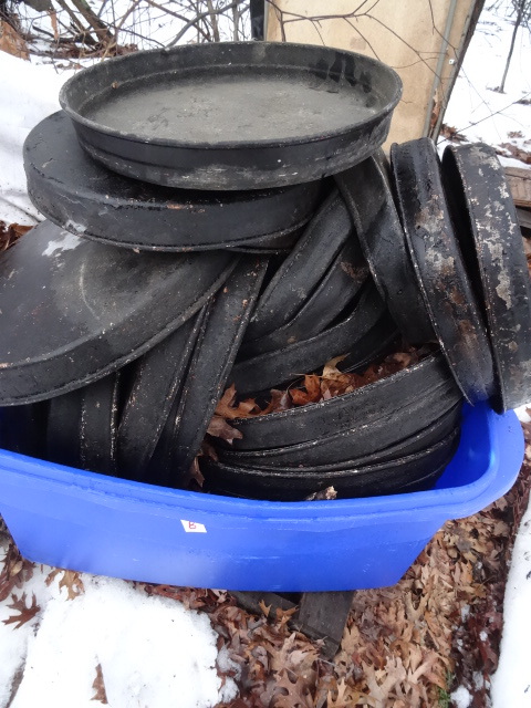 Bin of aluminum pizza pans. Deep di...